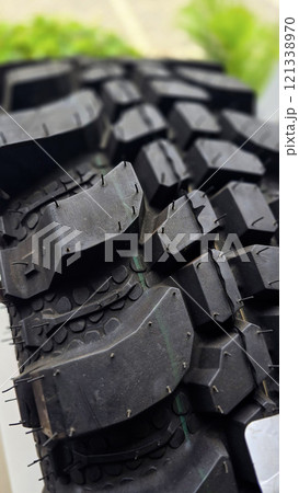 detailed image of a brand new car tire showcasing its intricate tread pattern for enhanced grip and performance 121338970