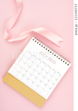 July 2025 desk calendar with pink ribbon. July 2025 desk calendar with pink ribbon. 121340737