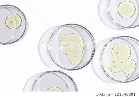 A skin serum or body gel or a drop of oil in a petri dish. 121340891