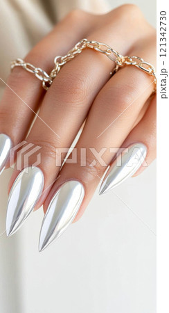 Metallic silver chrome nails closeup with rhinestone accents, vertical background 121342730