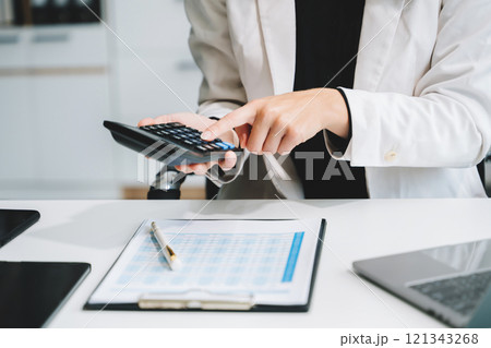 businesswoman or accountant hand typing laptop working to calculate on desk about cost 121343268