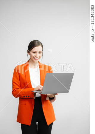 Portrait photo of young beautiful woman feeling happy and holding smart phone, tablet and laptop with black empty screen on white background can use for advertising or product presenting concept. 121343302
