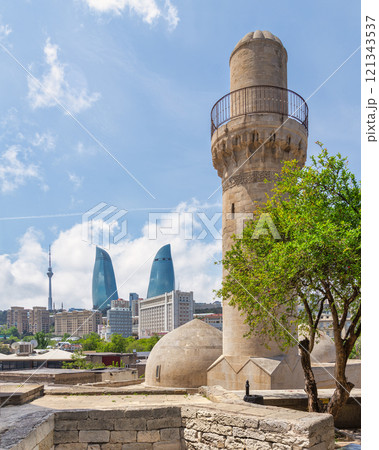 Minaret of Shah Mosque and Flame Towers contrasting the skyline of Baku, Azerbaijan Minaret of Shah Mosque and Flame Towers contrasting the skyline of Baku, Azerbaijan 121343537