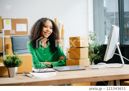 Young business owner woman prepare parcel box and standing check online orders for deliver Young business owner woman prepare parcel box and standing check online orders for deliver 121343631