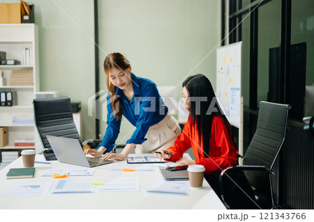 Asian business colleague business presents and explains and using laptop and tablet. Teamwork, financial 121343766