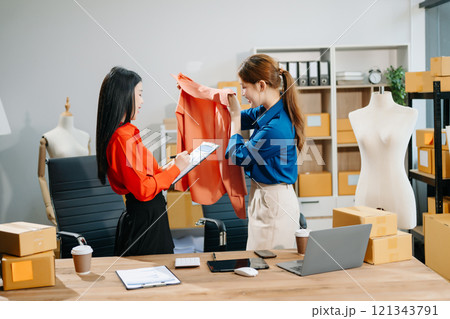 Two professional young Asia cheerful lady fashion designer teamwork with casual site Two professional young Asia cheerful lady fashion designer teamwork with casual site 121343791