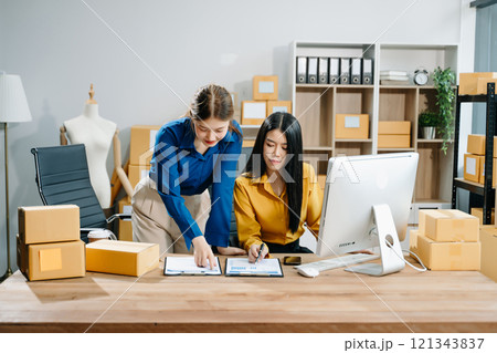 Small business entrepreneur SME freelance Asian woman and woman working at home office 121343837