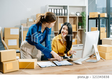 Small business entrepreneur SME freelance Asian woman and woman working at home office 121343838