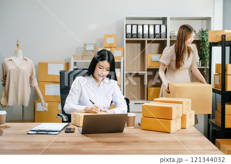 Small business entrepreneur SME freelance Asian woman and woman working at home office Small business entrepreneur SME freelance Asian woman and woman working at home office 121344032