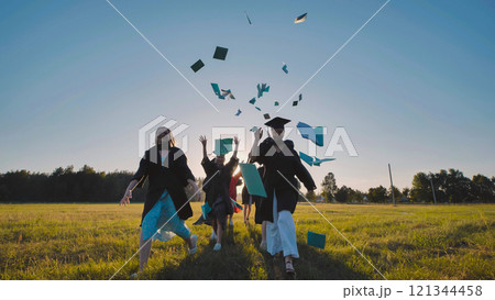 Graduates joyfully throwing books into the air, celebrating the exciting end of high school and embracing new beginnings together 121344458