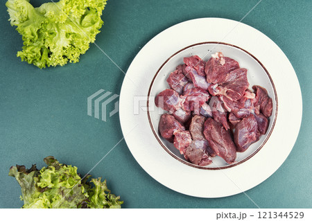 Uncooked raw deer meat fillets. 121344529