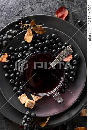 Black chokeberry juice, fresh berries, and pieces of brown sugar. Black chokeberry juice, fresh berries, and pieces of brown sugar. 121344706