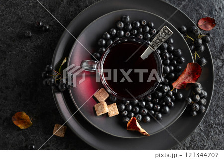 Black chokeberry juice, fresh berries, and pieces of brown sugar. 121344707