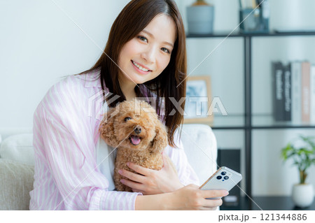 部屋でペットとくつろぐ若い女性 部屋でペットとくつろぐ若い女性 121344886