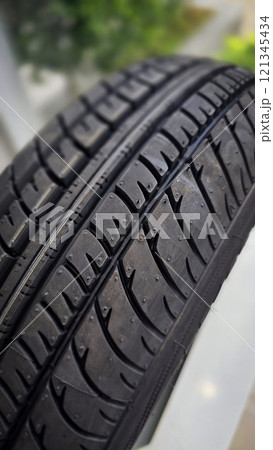 detailed image of a brand new car tire showcasing its intricate tread pattern for enhanced grip and performance 121345434