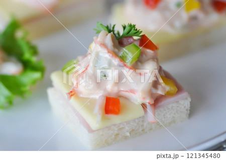 canape or toast with ham , cheese , crab stick and tuna 121345480