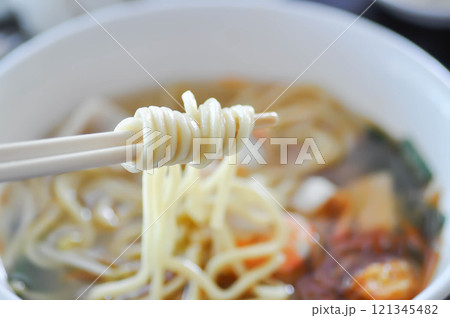 eating noodles with fish and shrimp or shrimp and fish noodles or Chinese noodles 121345482