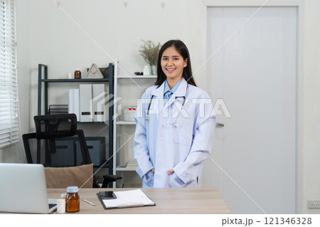 Confident Female Doctor in Modern Office Setting with Medical Equipment and Professional Attire 121346328