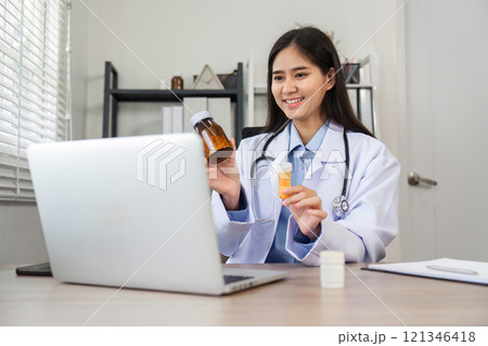 Female Doctor Providing Online Health Advice via Video Call in Modern Medical Office Setting Female Doctor Providing Online Health Advice via Video Call in Modern Medical Office Setting 121346418