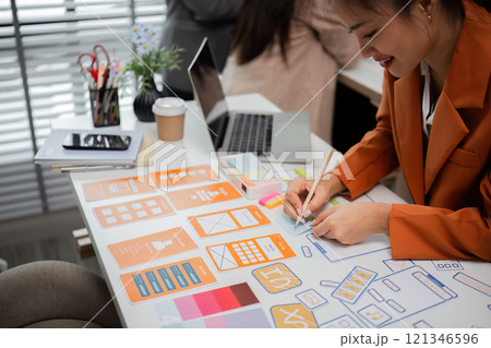 Creative Team of Graphic Designers Collaborating on Innovative Projects in a Modern Office Environment 121346596