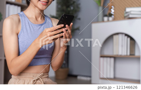 Young Healthy Woman Relaxing at Home After Yoga Session, Embracing Wellness and Tranquility in a Modern Living Space 121346626