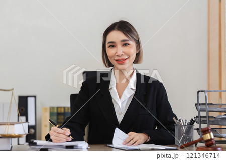 Professional Female Lawyer Reviewing Legal Contract Documents in Office Setting for Lawsuit Preparation Professional Female Lawyer Reviewing Legal Contract Documents in Office Setting for Lawsuit Preparation 121346714