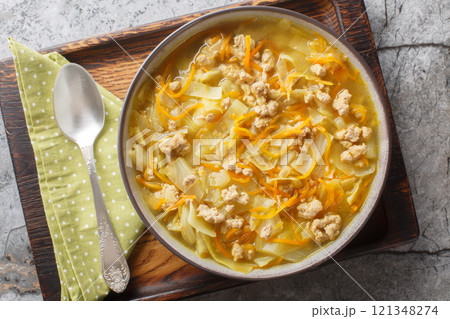 Asian rich egg roll soup with minced meat, cabbage, carrot, onion and spices close-up in a bowl. Horizontal top view 121348274