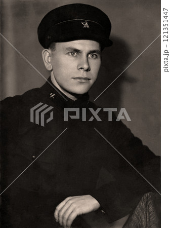 Vintage portrait of a young man in the uniform of a USSR railway worker. Retro photo from 1937 121351447