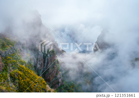 A mountain covered in fog and clouds. Madeira island, Portugal A mountain covered in fog and clouds. Madeira island, Portugal 121351661