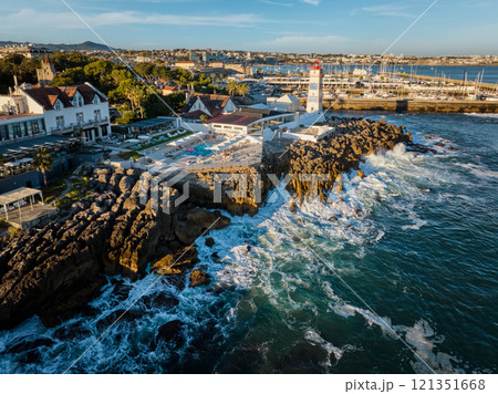 Aerial view of Santa Marta lighthouse and Cascais marina with Cascais cityscape Aerial view of Santa Marta lighthouse and Cascais marina with Cascais cityscape 121351668