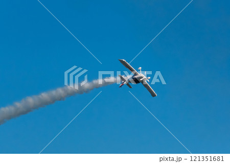 Stunt aerobatic plane performing stunts in air Stunt aerobatic plane performing stunts in air 121351681