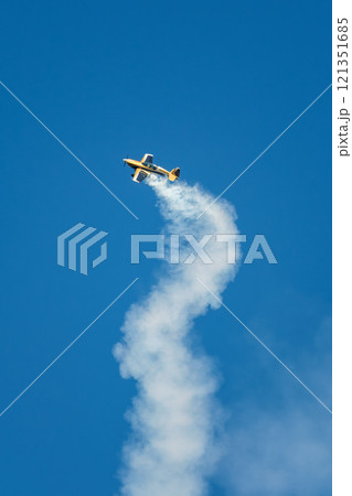 Stunt aerobatic plane performing stunts in air 121351685