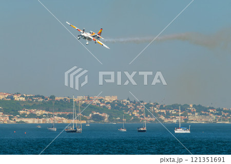 Stunt aerobatic plane performing stunts in air 121351691