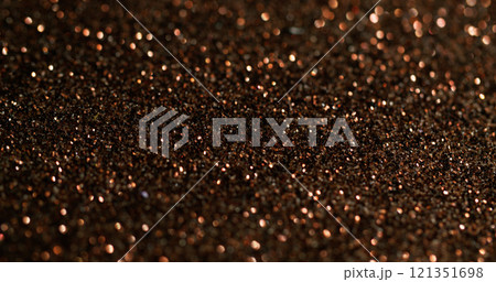 Bokeh powder. Golden glitter. Fading shimmering festive surface with fine metallic dust. Color precious shining glamour blur particles. Bokeh powder. Golden glitter. Fading shimmering festive surface with fine metallic dust. Color precious shining glamour blur particles. 121351698