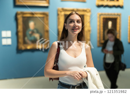 Girl view pictures and icons in museum hall 121351982