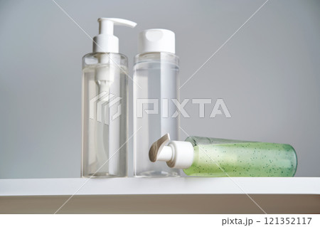 Three bottles of body care products on a white background. 121352117