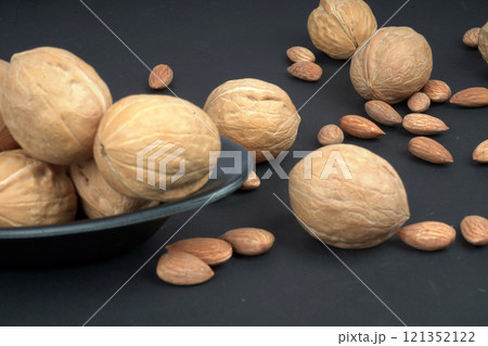 Almonds and walnuts in matte black background Almonds and walnuts in matte black background 121352122