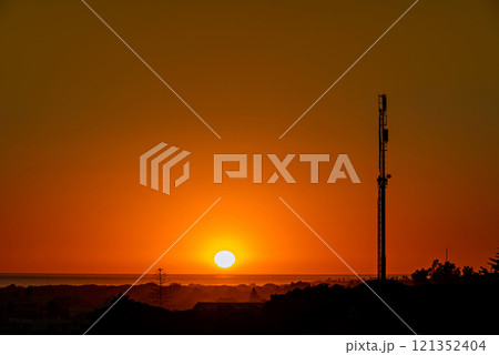 Beautiful sunset on the beach of Los Canos de Meca with the background of the Trafalgar Lighthouse, Barbate, Cadiz 121352404