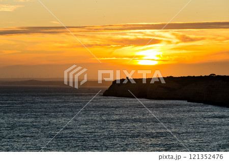 Sunset at Carvoeiro beach, in Lagoa, Algarve region, Portugal 121352476