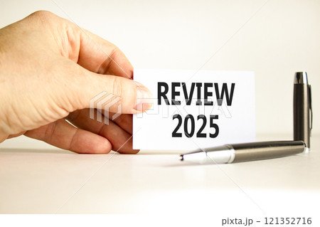 Planning 2025 review new year symbol. Concept words 2025 Review on beautiful white card. Beautiful white background. Businessman hand. Business 2025 review new year concept. Copy space. Planning 2025 review new year symbol. Concept words 2025 Review on beautiful white card. Beautiful white background. Businessman hand. Business 2025 review new year concept. Copy space. 121352716
