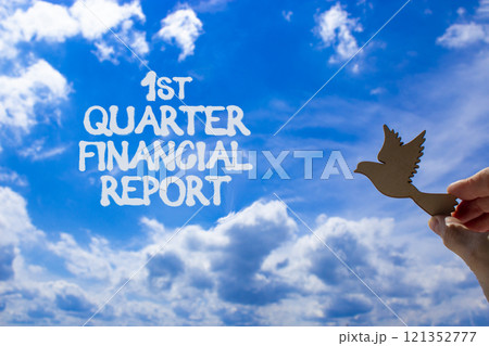 1st quarter financial report symbol. Concept words 1st quarter financial report. Beautiful blue sky and clouds background. Businessman hand. Business 1st quarter financial report concept. Copy space. 121352777