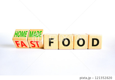 Fast or homemade food symbol. Concept words Fastfood or Homemade food on wooden cubes. Beautiful white table white background. Healthy lifestyle Fast or homemade food concept. Copy space 121352820