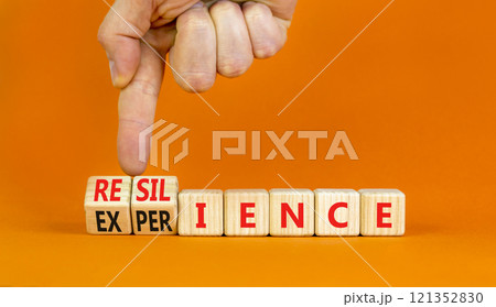 Resilience or experience symbol. Concept words Resilience Experience on beautiful wooden blocks. Beautiful orange background. Businessman hand. Business resilience or experience concept. Copy space Resilience or experience symbol. Concept words Resilience Experience on beautiful wooden blocks. Beautiful orange background. Businessman hand. Business resilience or experience concept. Copy space 121352830