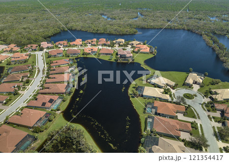 Consequences of natural disaster. Heavy flood with high water surrounding residential houses after hurricane Ian rainfall in Florida residential area 121354417