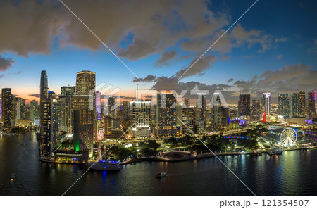 Brightly illuminated high skyscraper buildings in downtown district of Miami Brickell in Florida, USA. American megapolis with business financial district at night 121354507