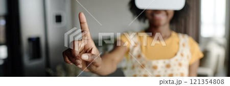 Website Banner with smiling woman wearing white VR goggles and demonstrating index finger Website Banner with smiling woman wearing white VR goggles and demonstrating index finger 121354808