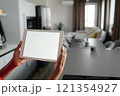 High angle shot of unrecognizable woman holding touchpad with white screen 121354927