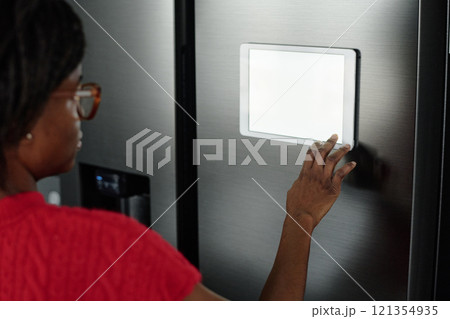 High angle shot of unrecognizable housewife installing app for smart home to control refrigerator 121354935