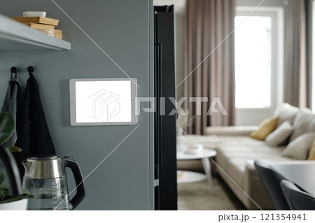 Medium close up of white tablet on smart fridge in kitchen 121354941