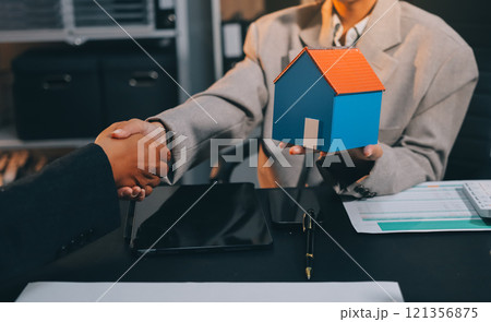 Close up Business people or Real Estate agent explain signing agreement for sale house to client. Property, Insurance, Broker concept. 121356875